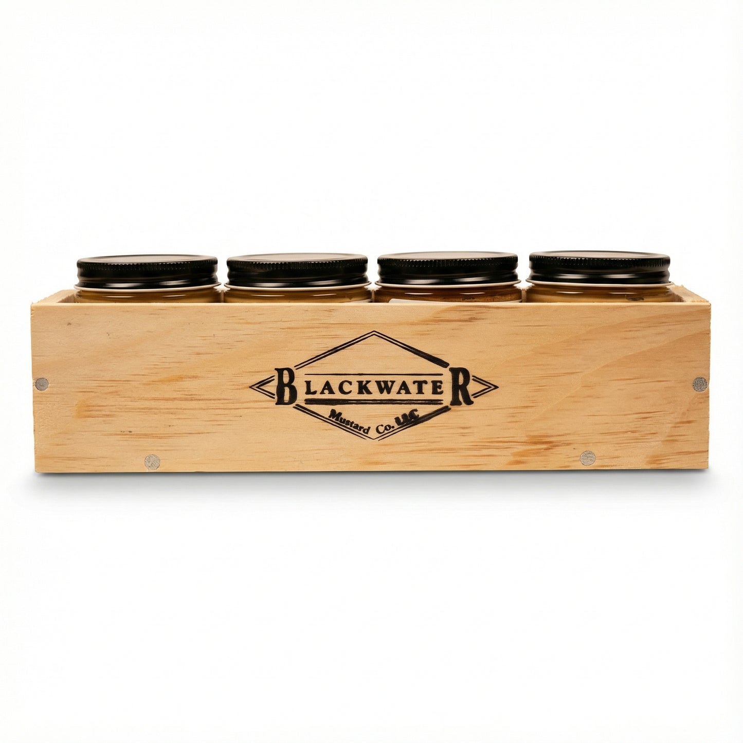 Wooden box with four jars labeled 'Blackwater' on a white background